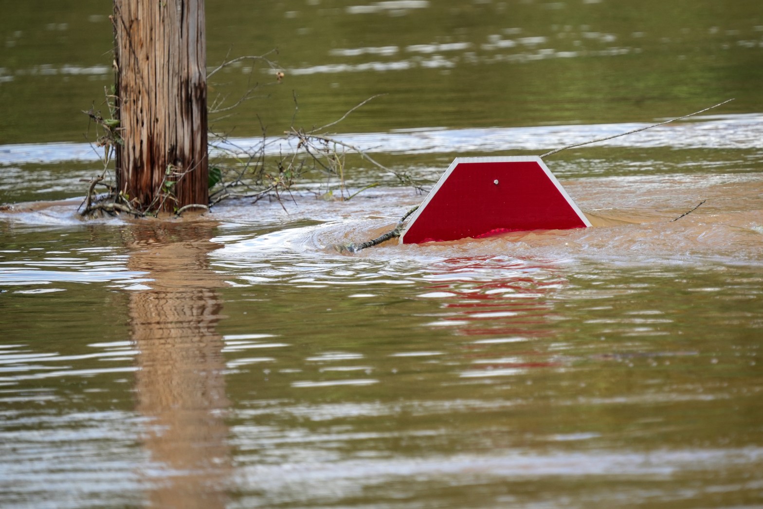top of stop sign sticking out of storm waters from hurricane Helene