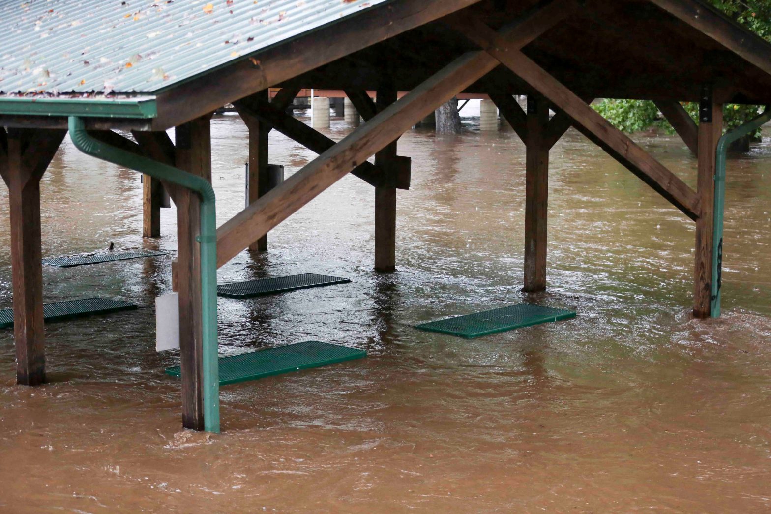 A picnic shelter with water rising up to the tables