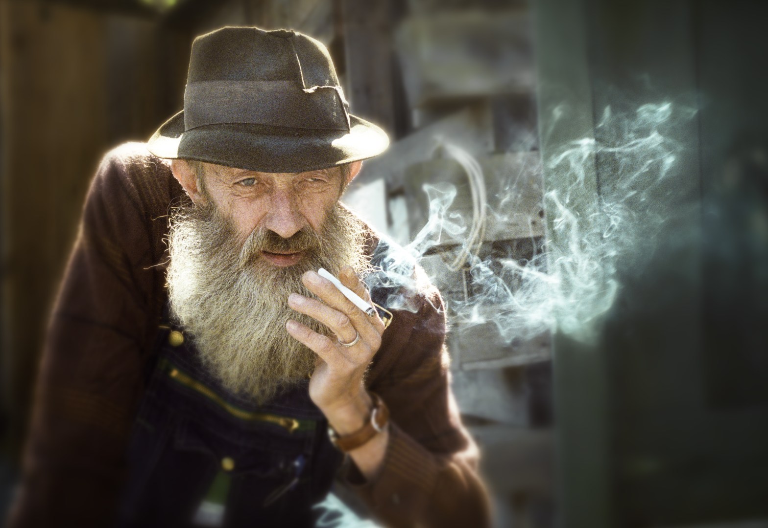A man in a hat smokes