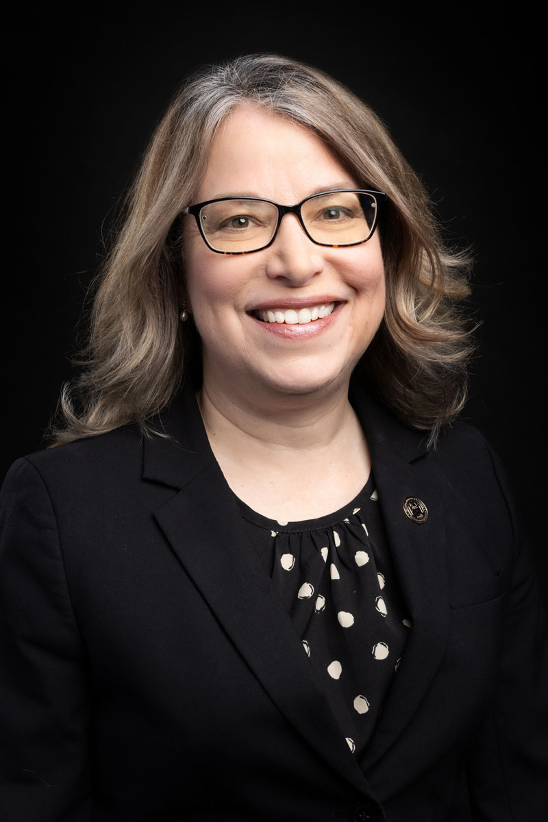 headshot of a woman in glasses